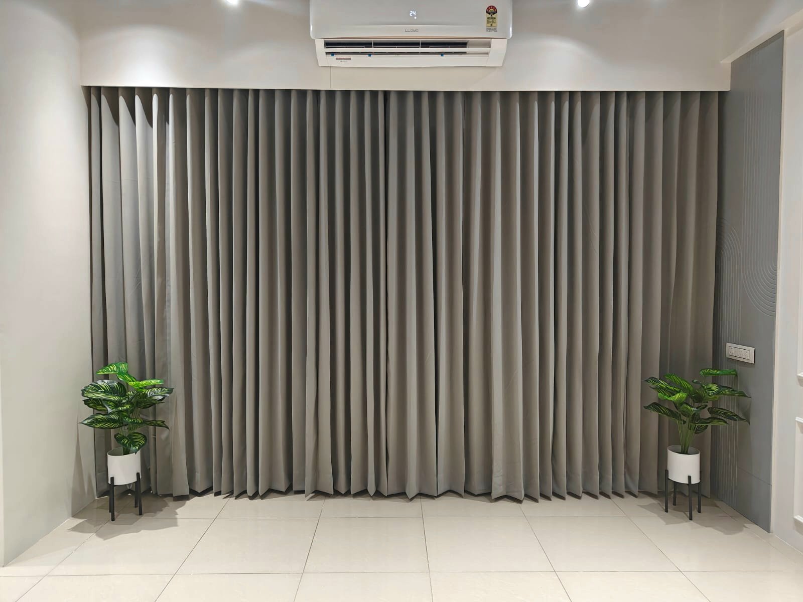 The full-width grey curtain wall, a plain backdrop for shoots