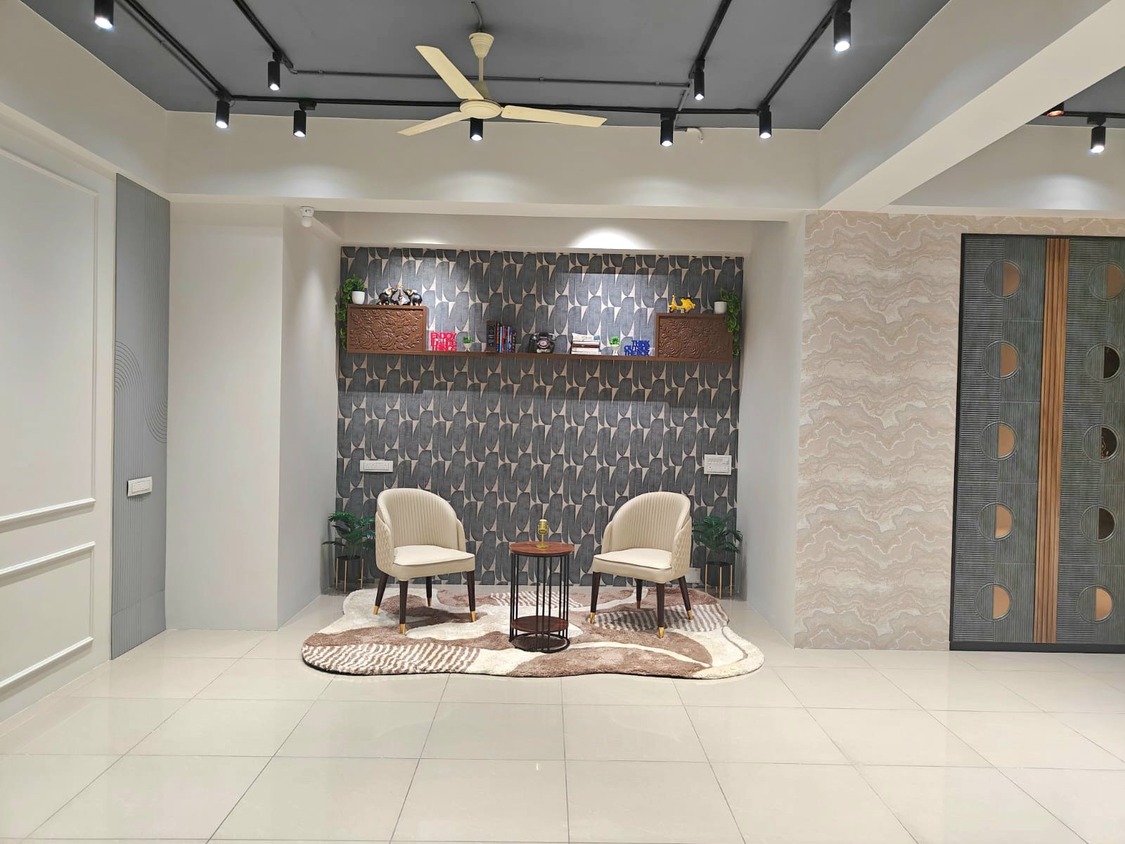 The seating corner with a display shelf and two armchairs